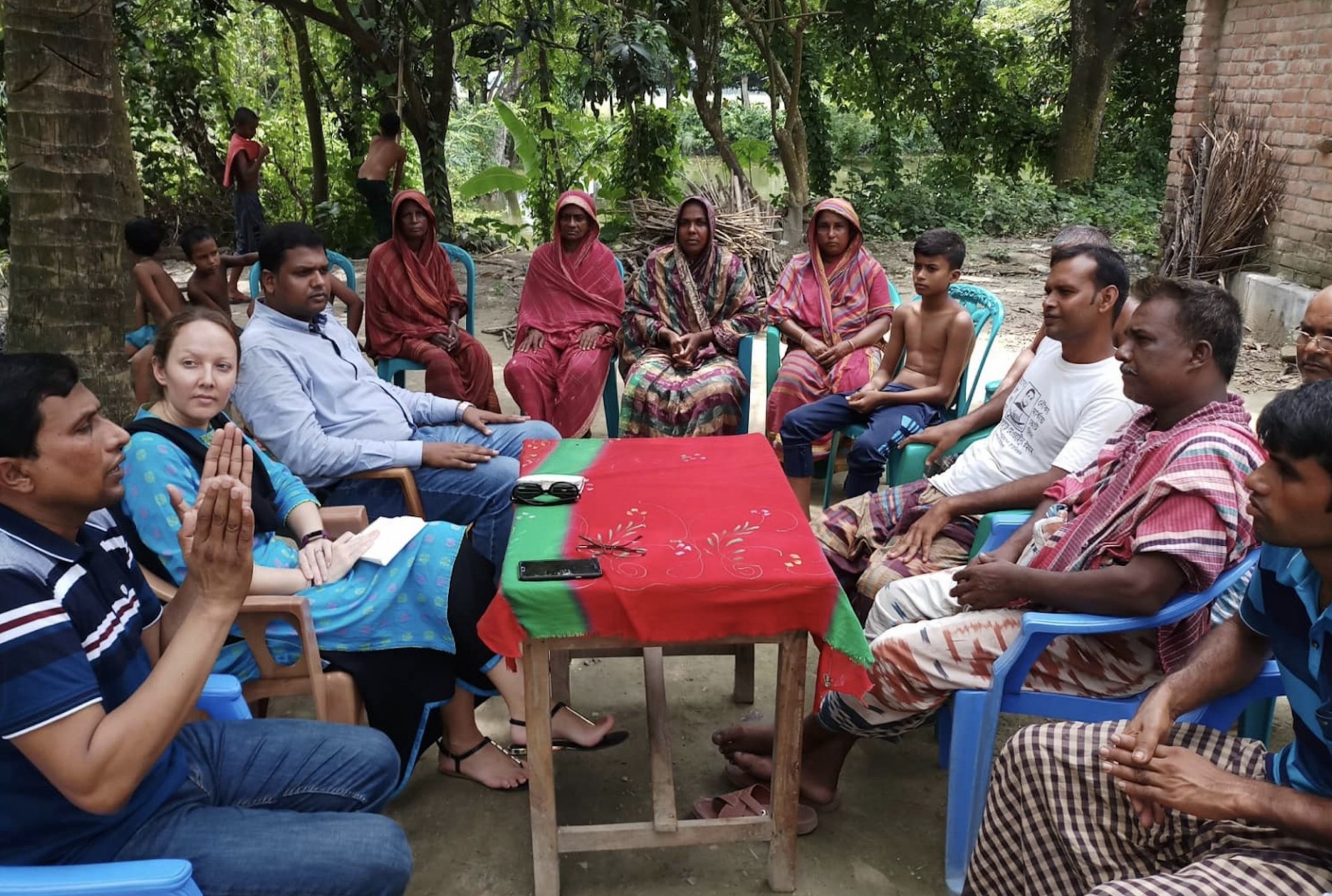 Photo of Sarah Johnson with farmers in Bangladesh. Credit: Mesbahul Haque.
